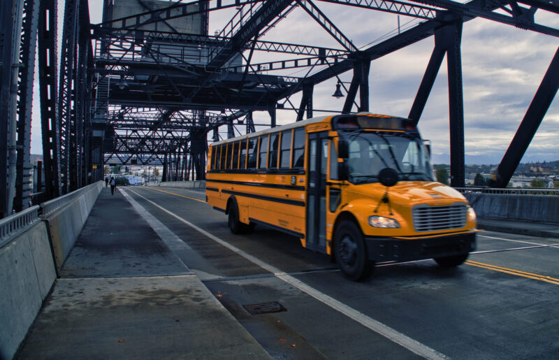 School bus rolling on bridge