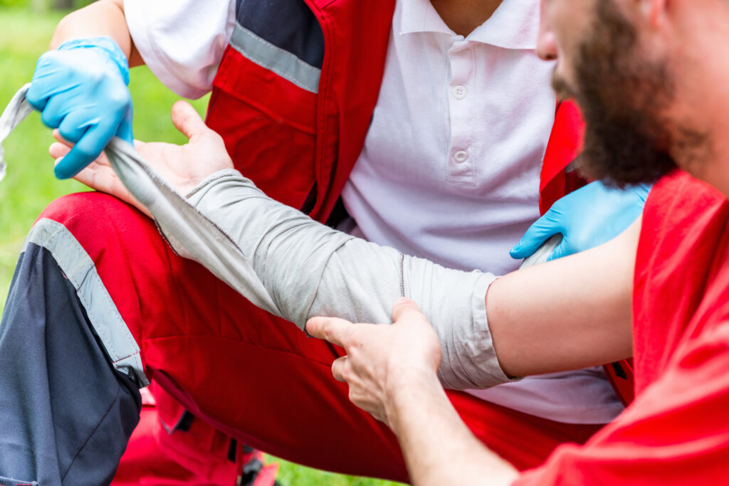 Medical worker treating burns on man's hand